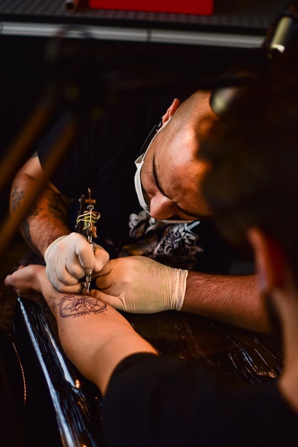 Isaac Roe, tattoo artist at BLACKWICK, at work